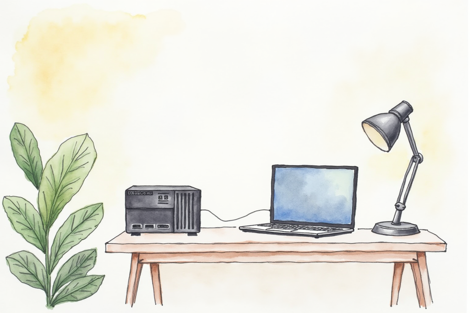 Home office desk with a small server-like device and a laptop